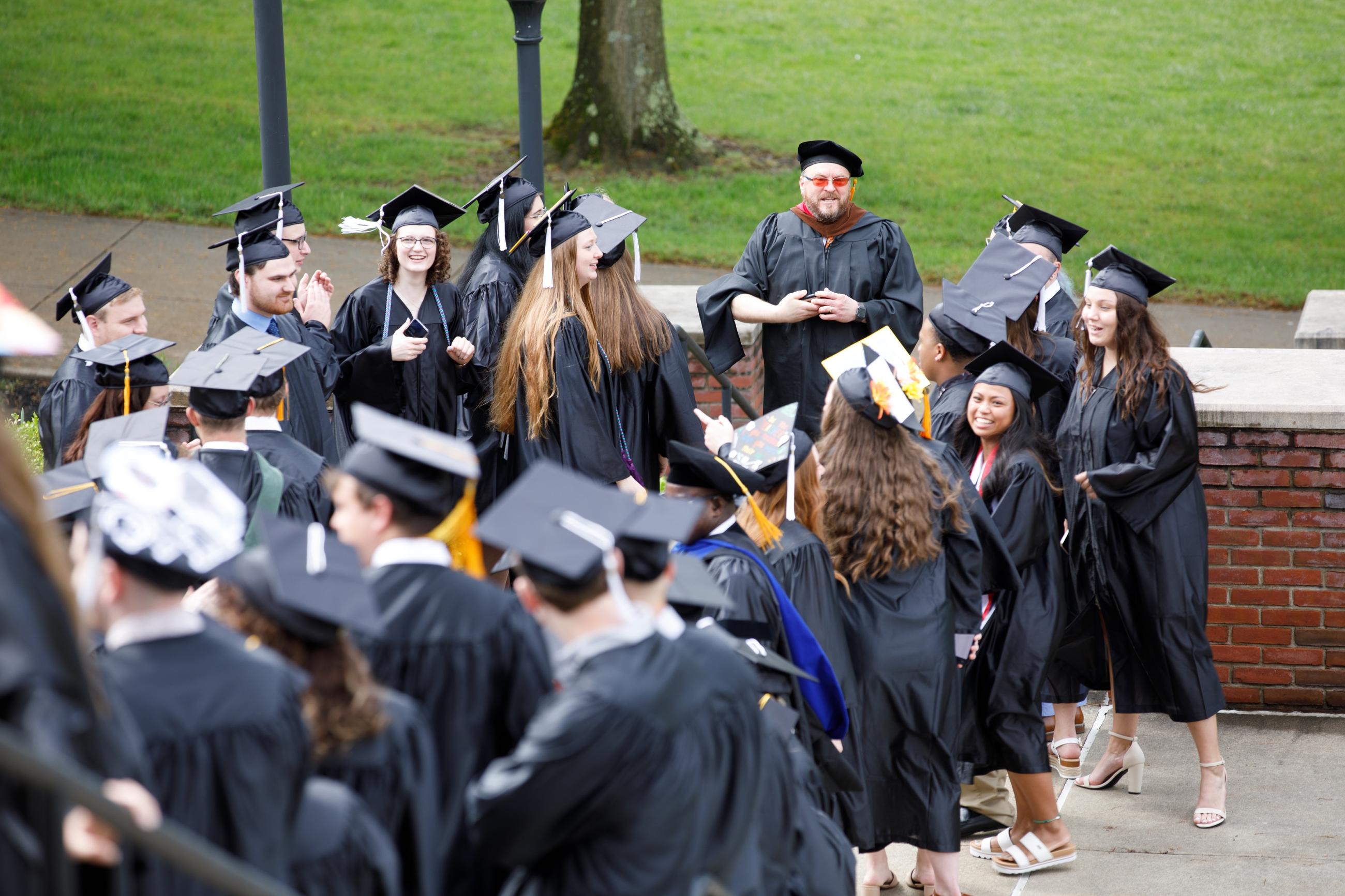 a crowd of students in academic regalia on graduation day