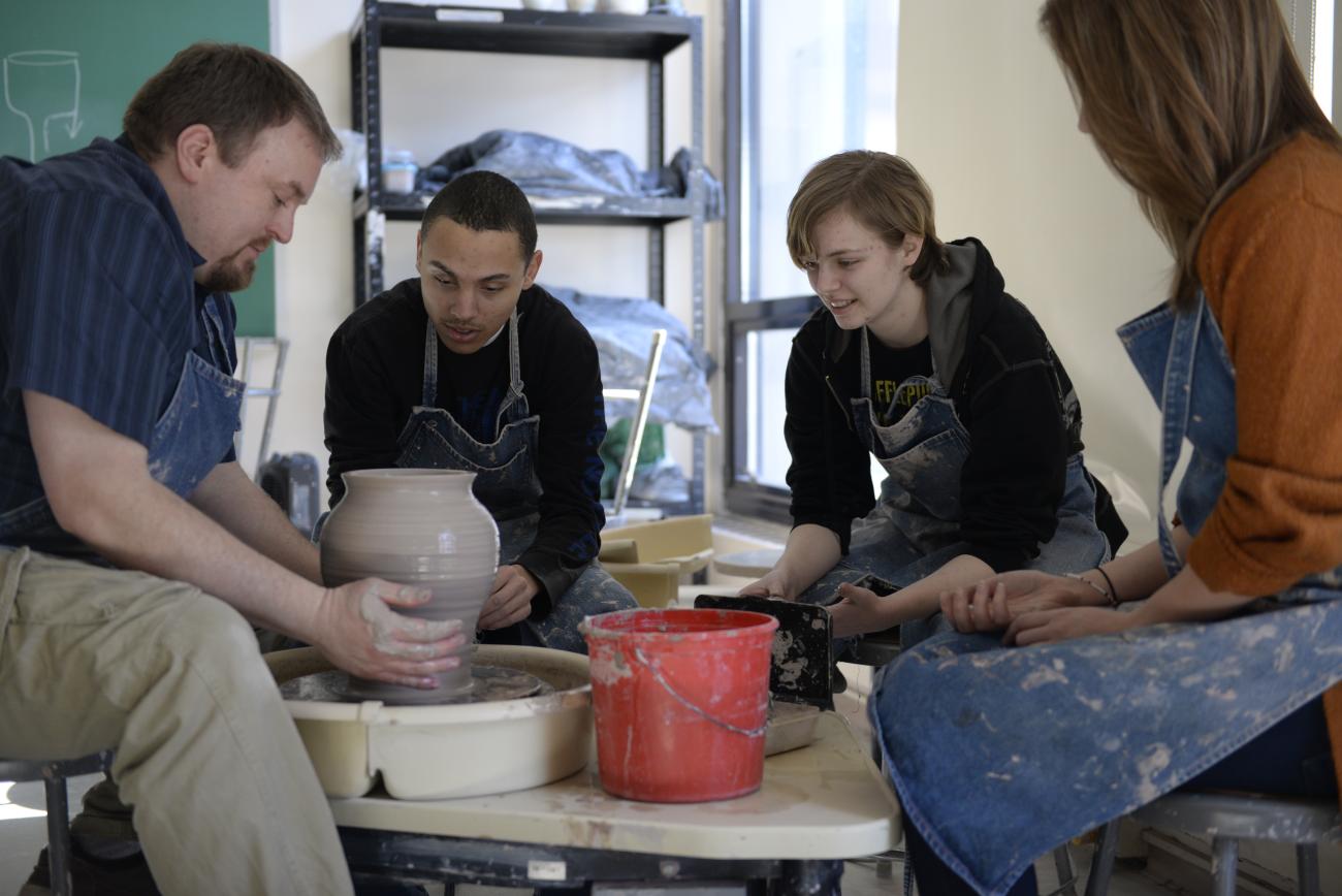 Students learn to spin pottery with Professor Heisey