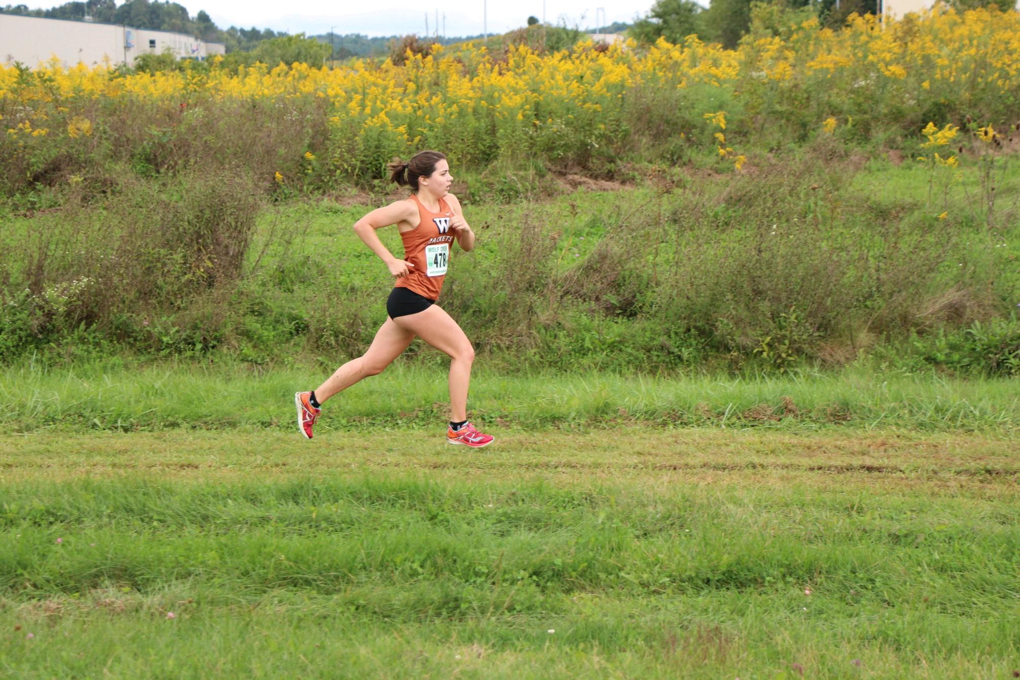 Teghan running towards the finish line