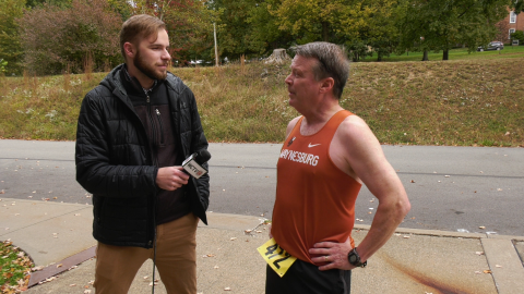 Micah Leith interviews President Lee during Homecoming 5K