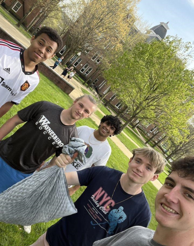 Michael Francus picking up trash on campus with friends