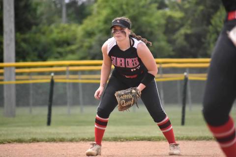 Sydney Fisher in her softball uniform on the field during a game