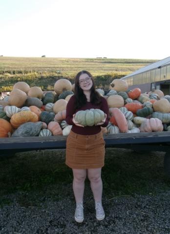 Aubrey pictured at a pumpkin patch in the fall. 