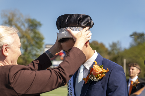 Provost Mindy Walls crowning Tyler Gordon Homecoming King