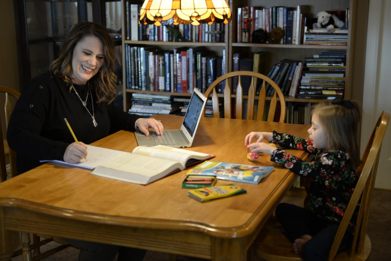 student studying with daughter