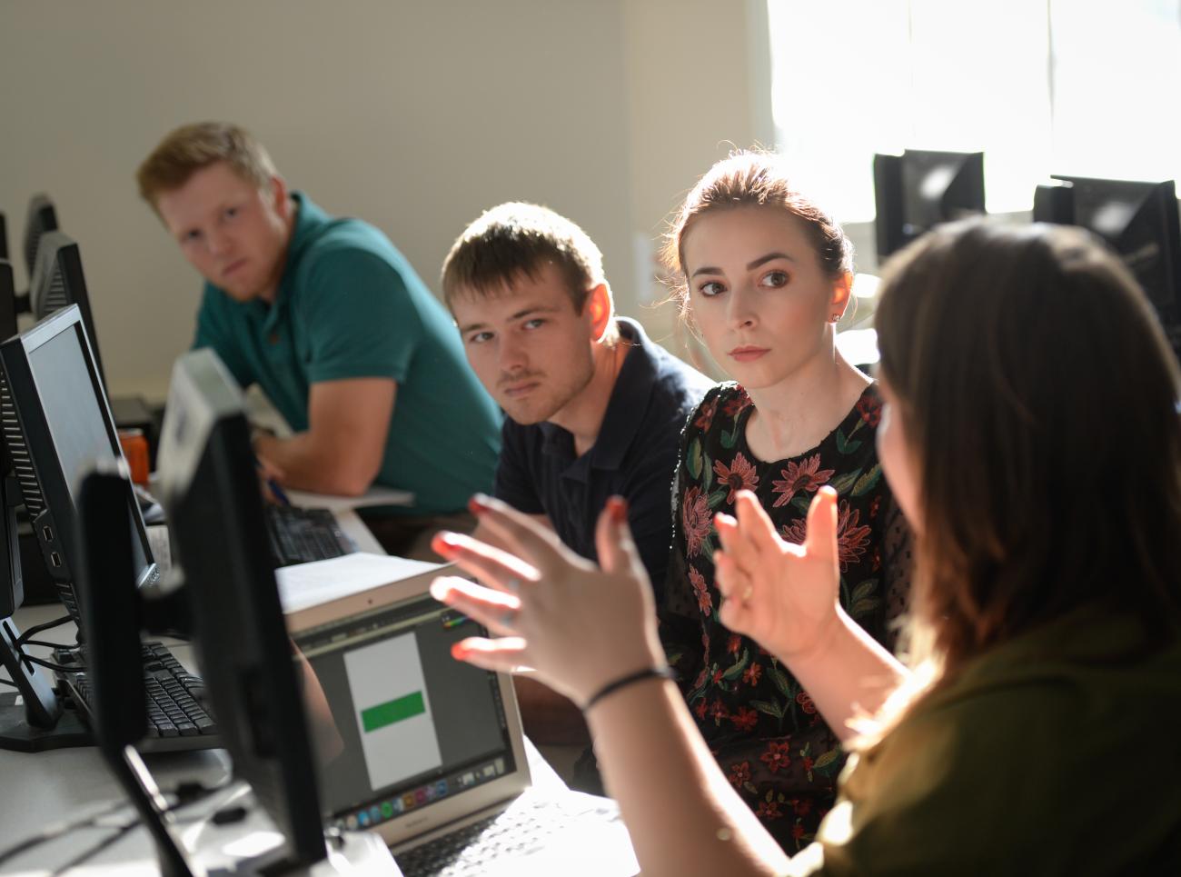 Students in discussion with professor.