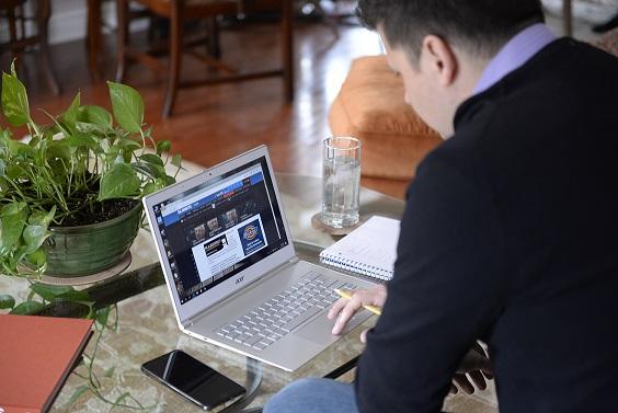 student working on computer at home