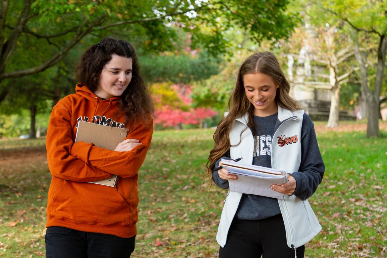 Two Waynesburg students walking on campus