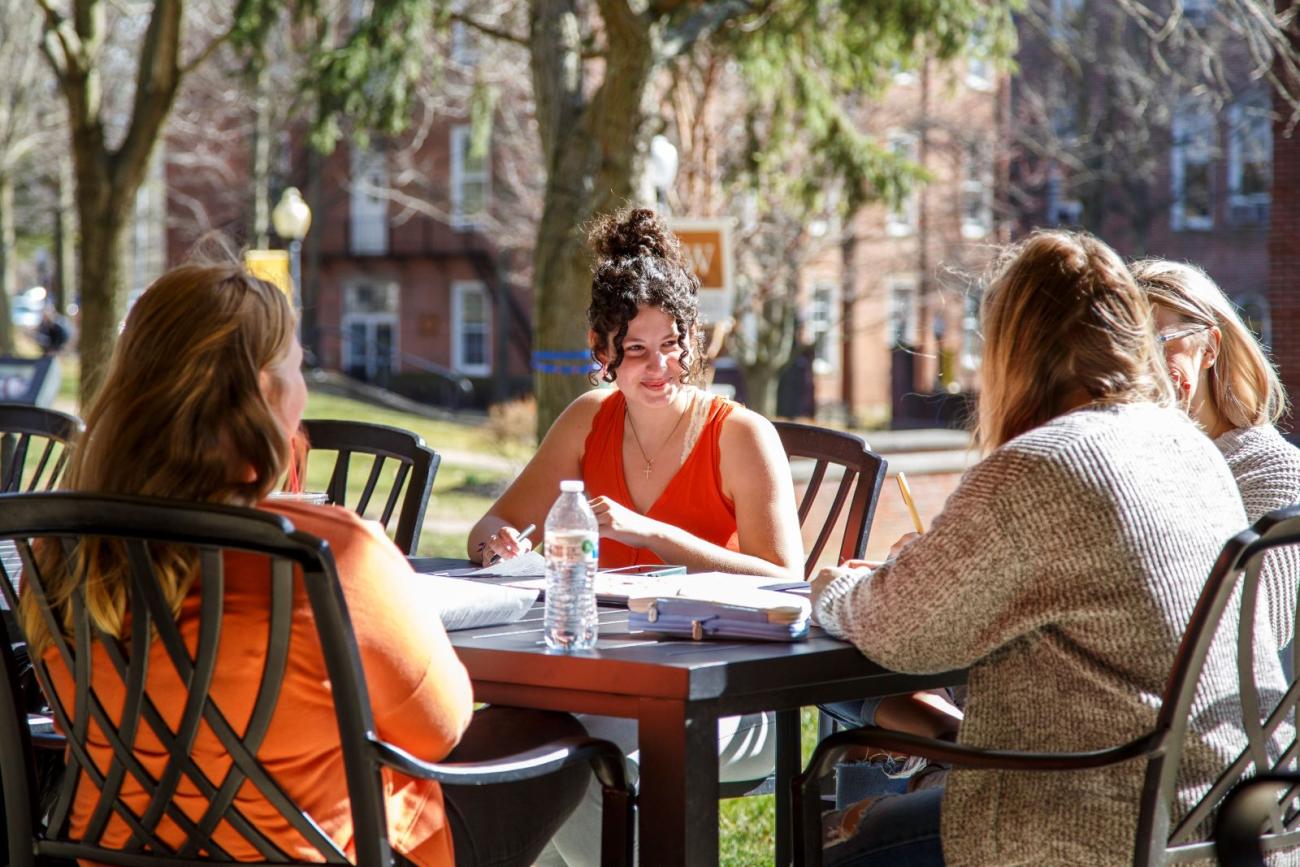 Waynesburg students workshopping at a picnic table
