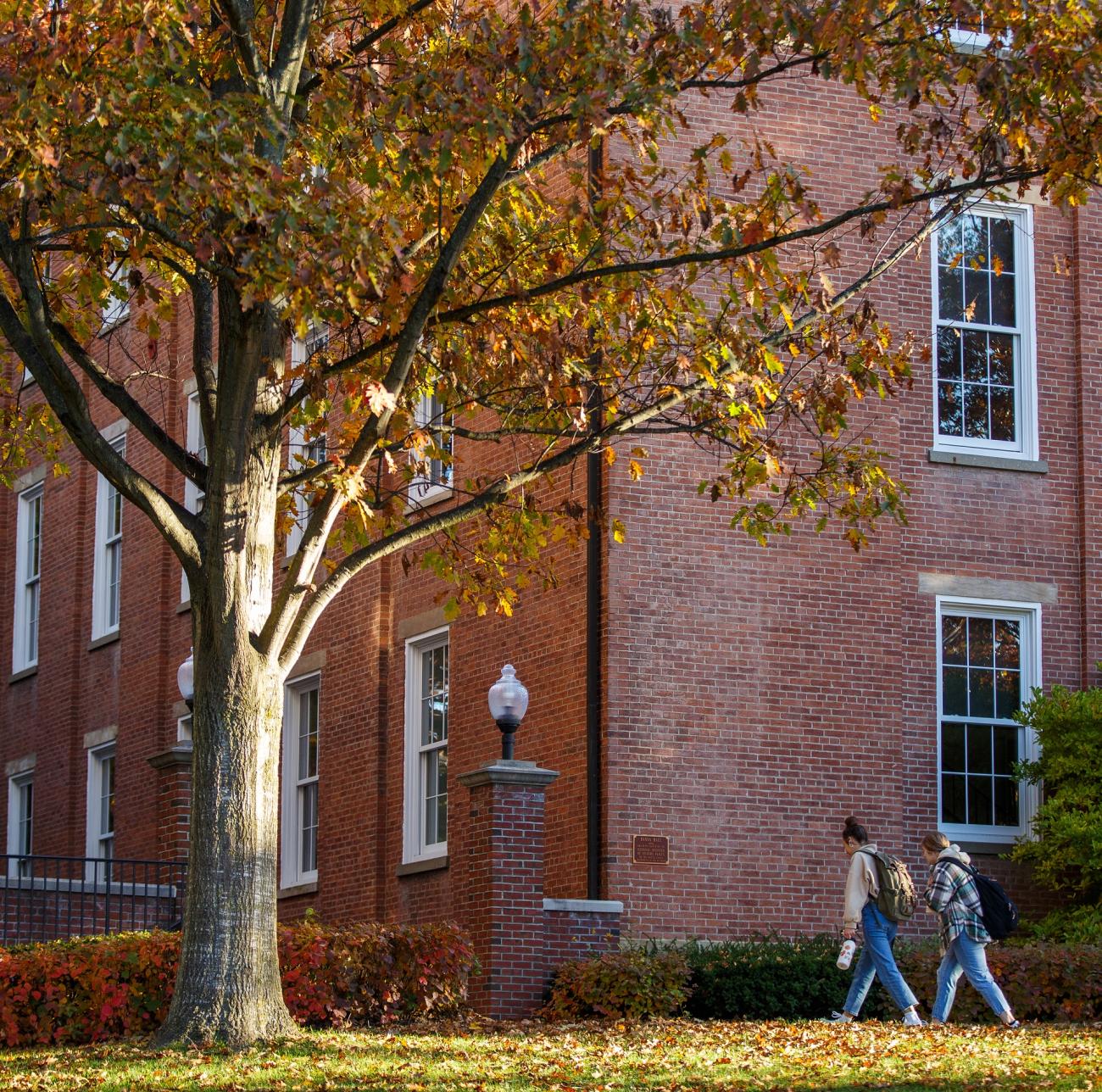 students walk next to Waynesburg University's historic Hanna Hall