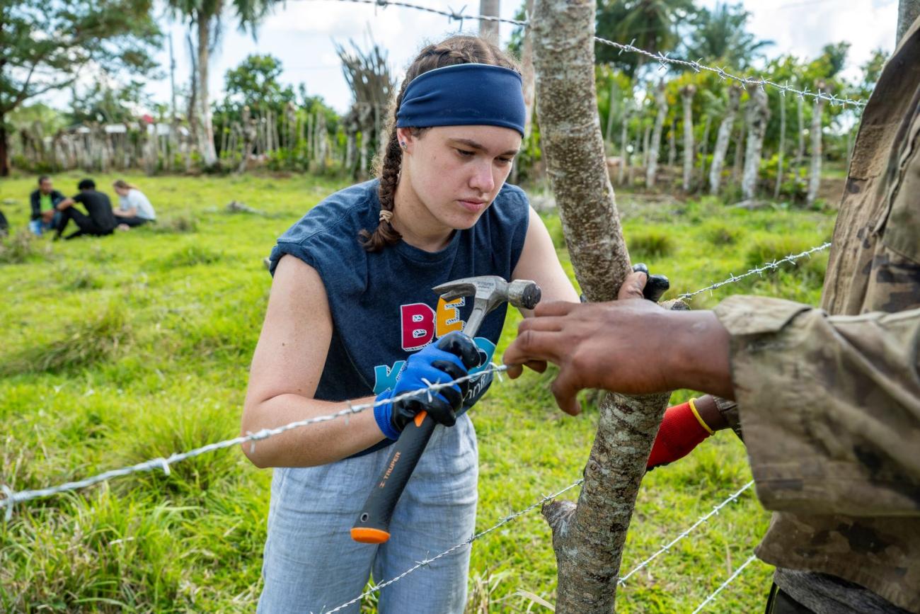Natalie Double helps build a new fence line on the spring 2025 trip