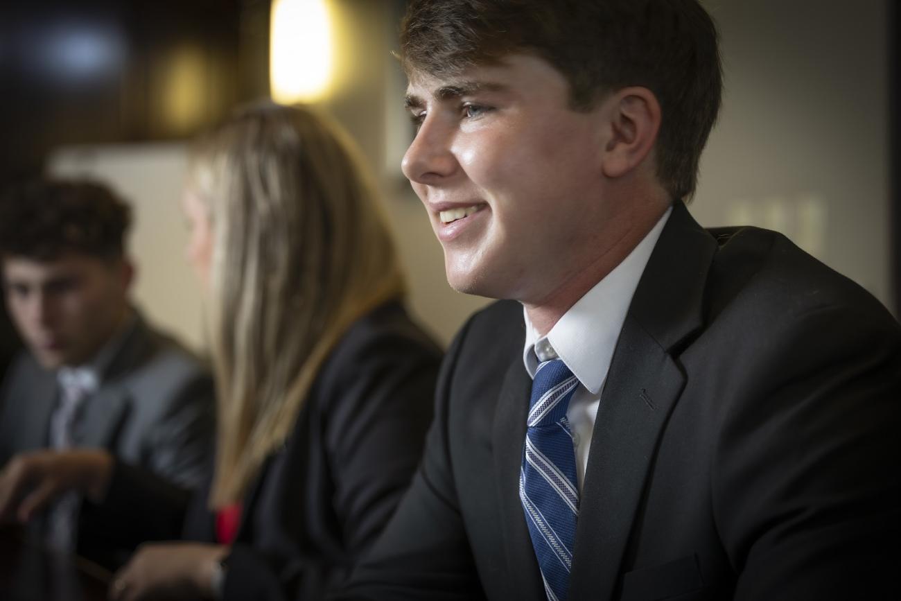 student in a suit at a stover scholar event