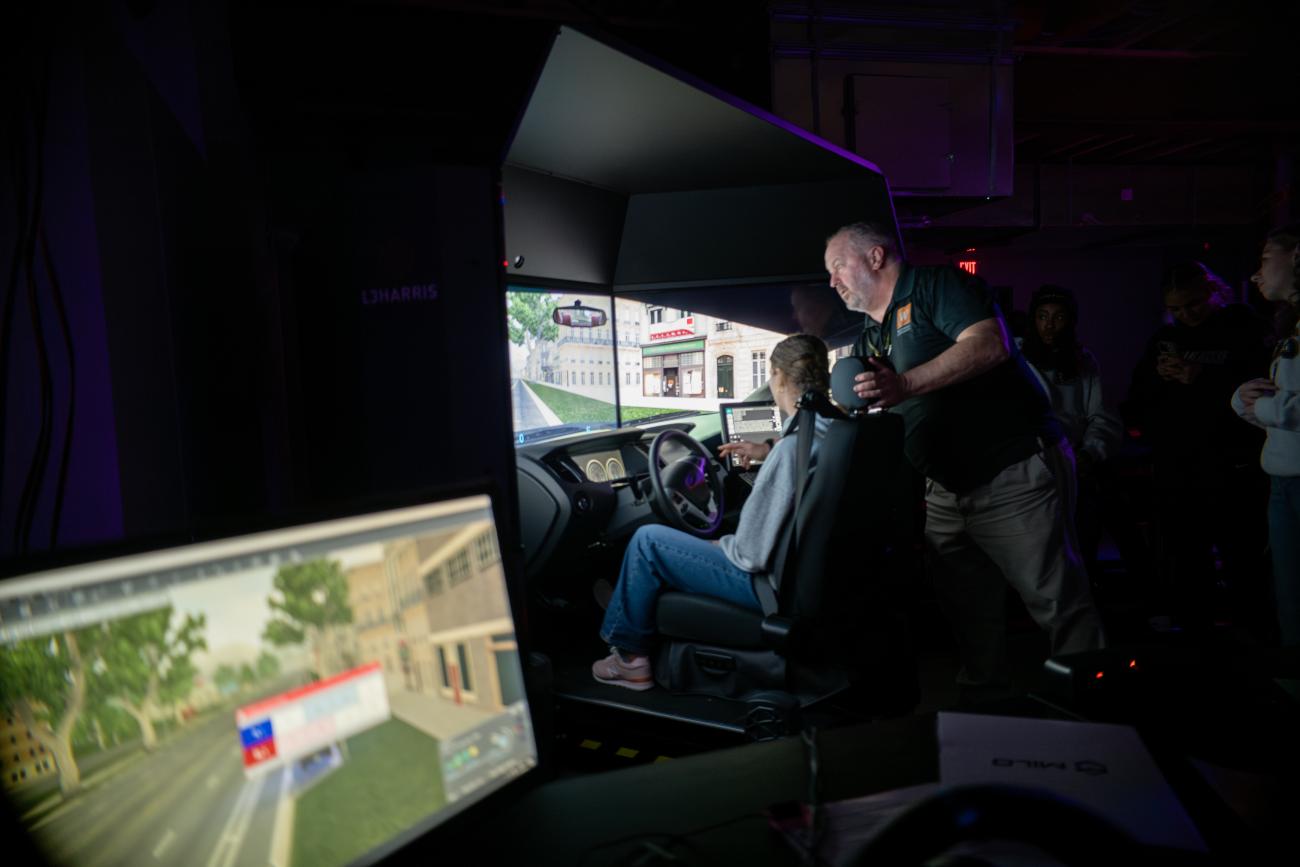 Students learning on the patrol simulator under the guide of a faculty member.
