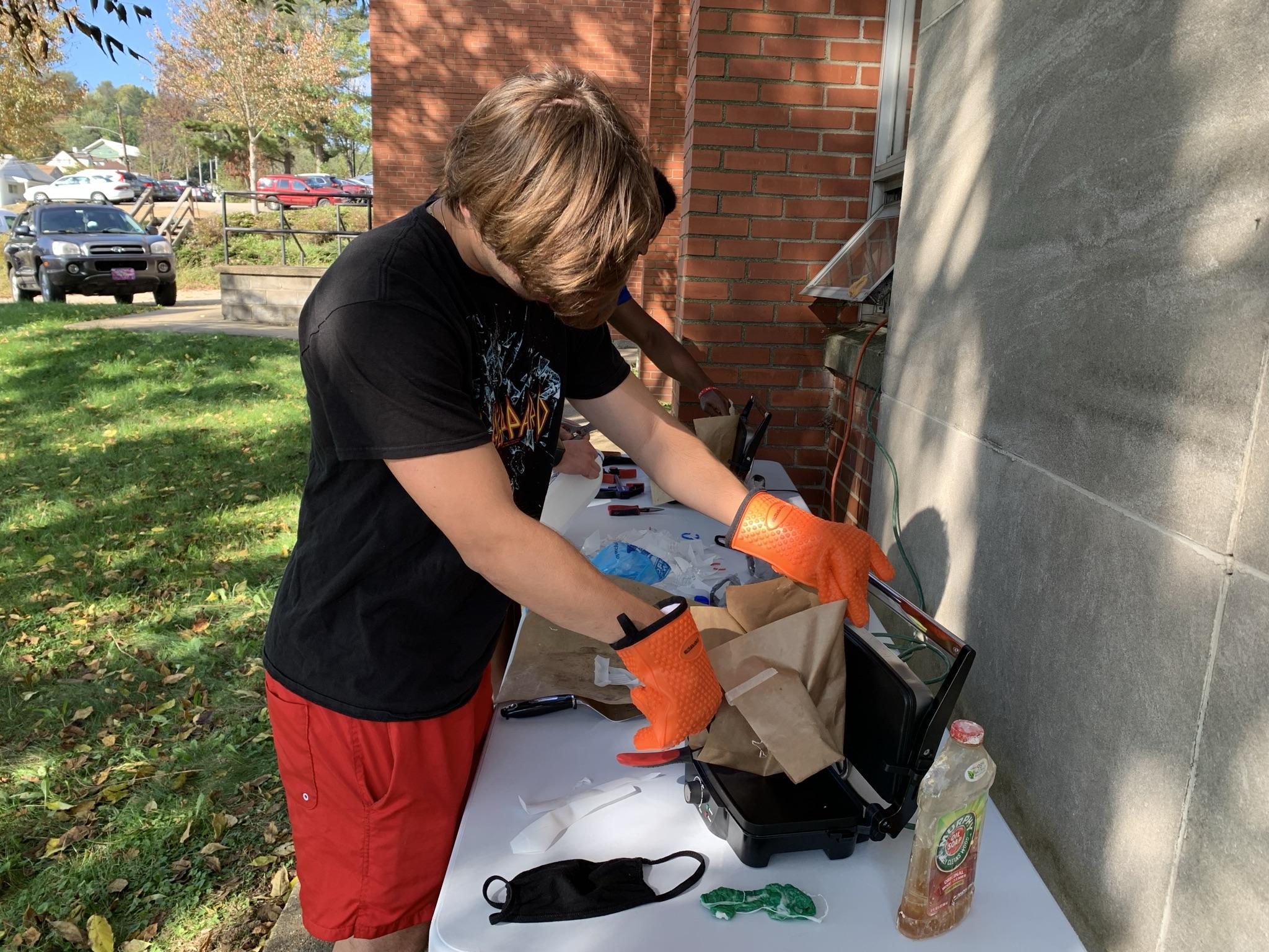 student melting plastic