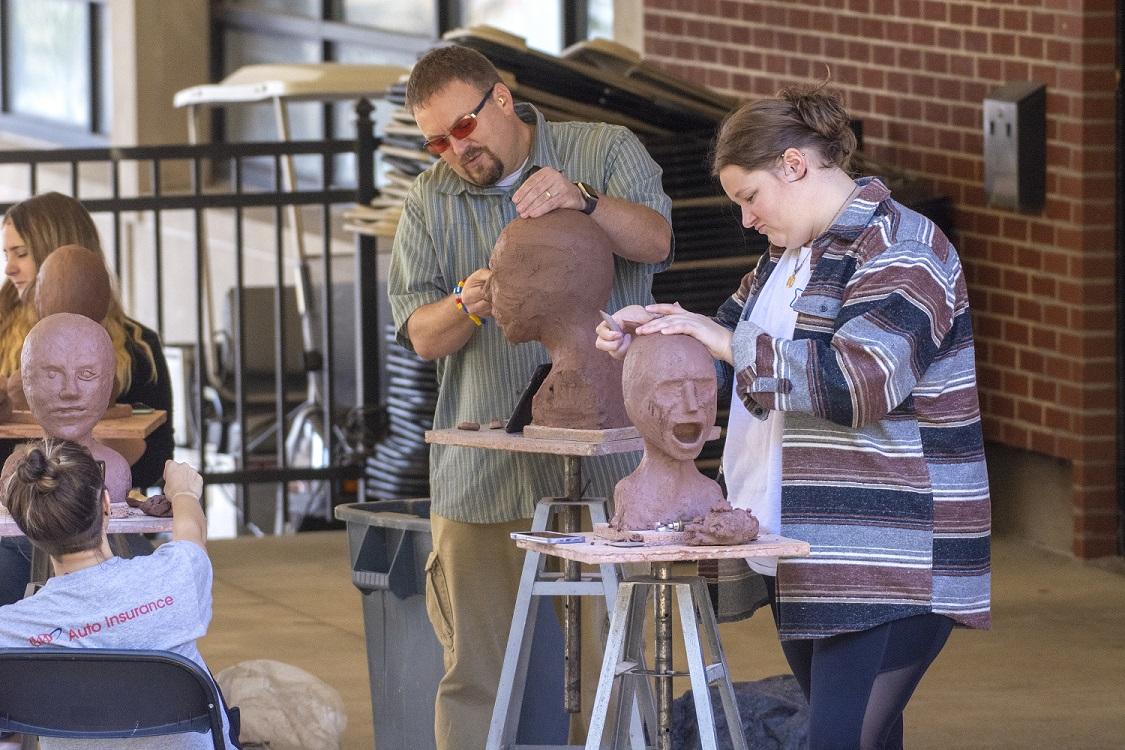 professor and student at outdoor art class 