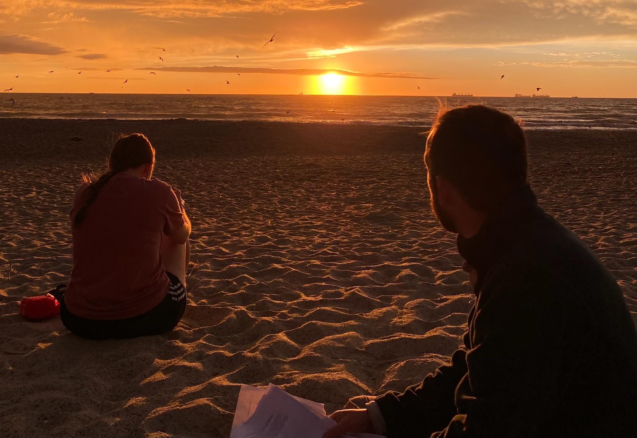 Students from WU A Rocha group on beach at sunrise