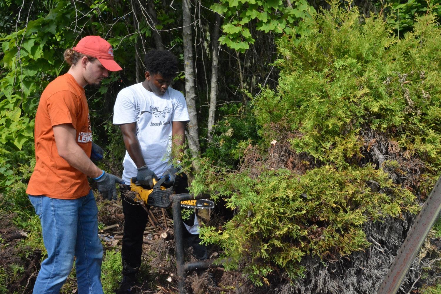 students doing yard work during welcome days