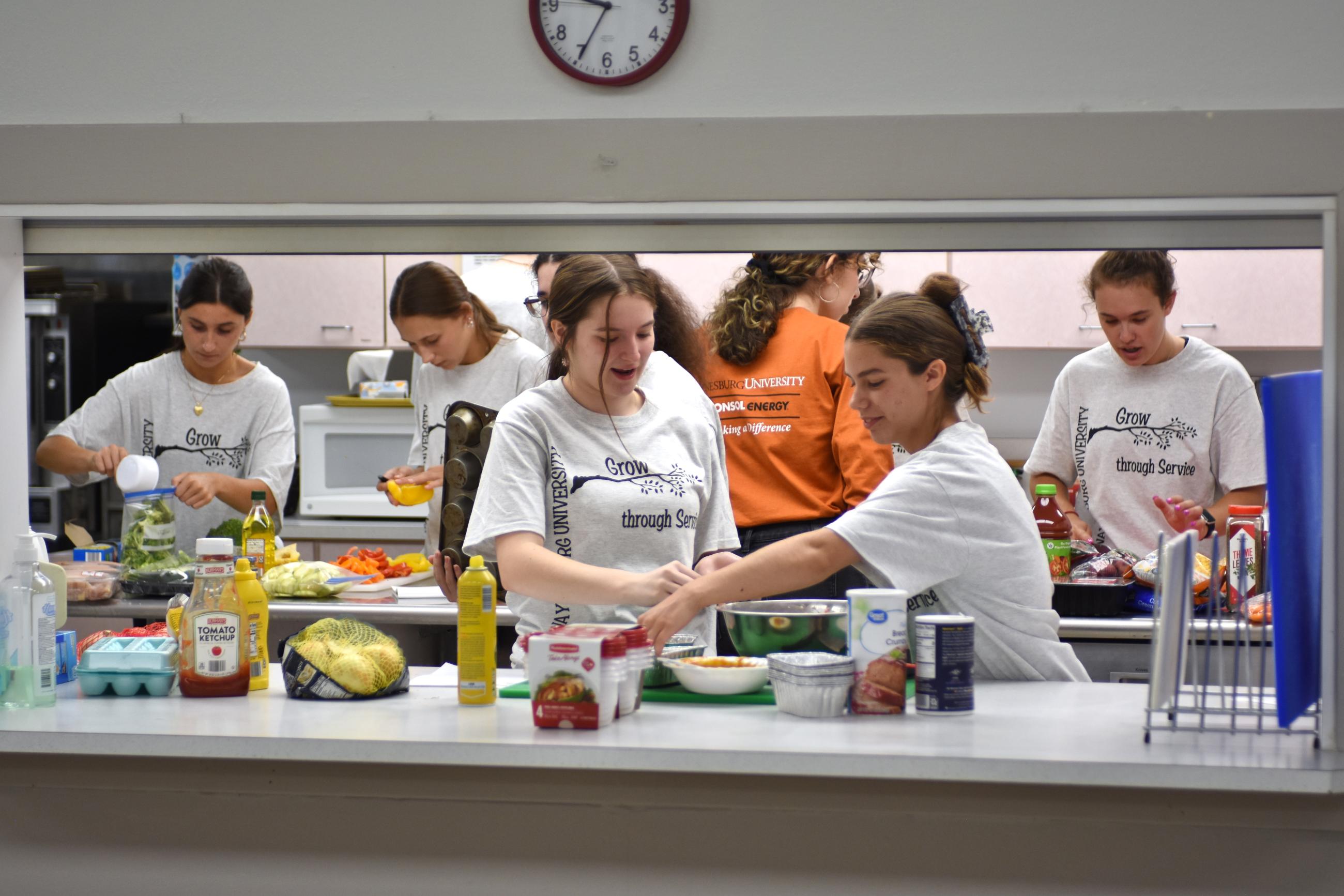 students working in a kitchen during service day
