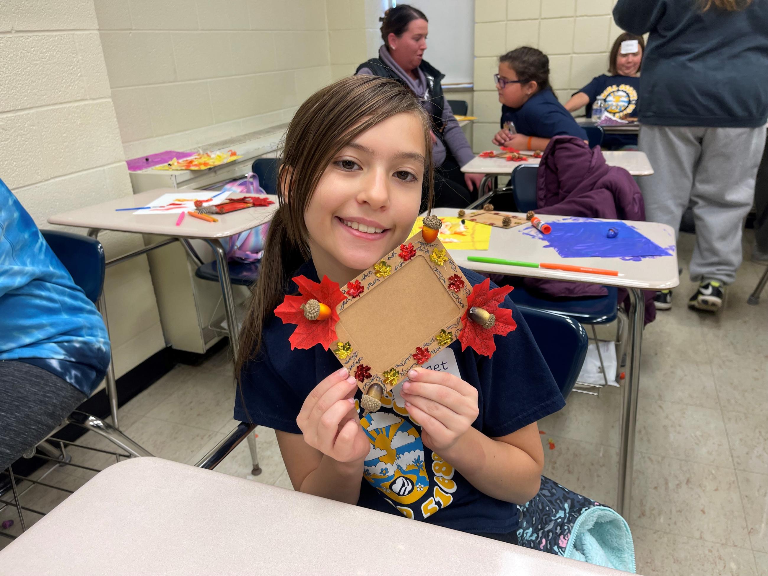 A Girl Scout shows her project during Badge Day