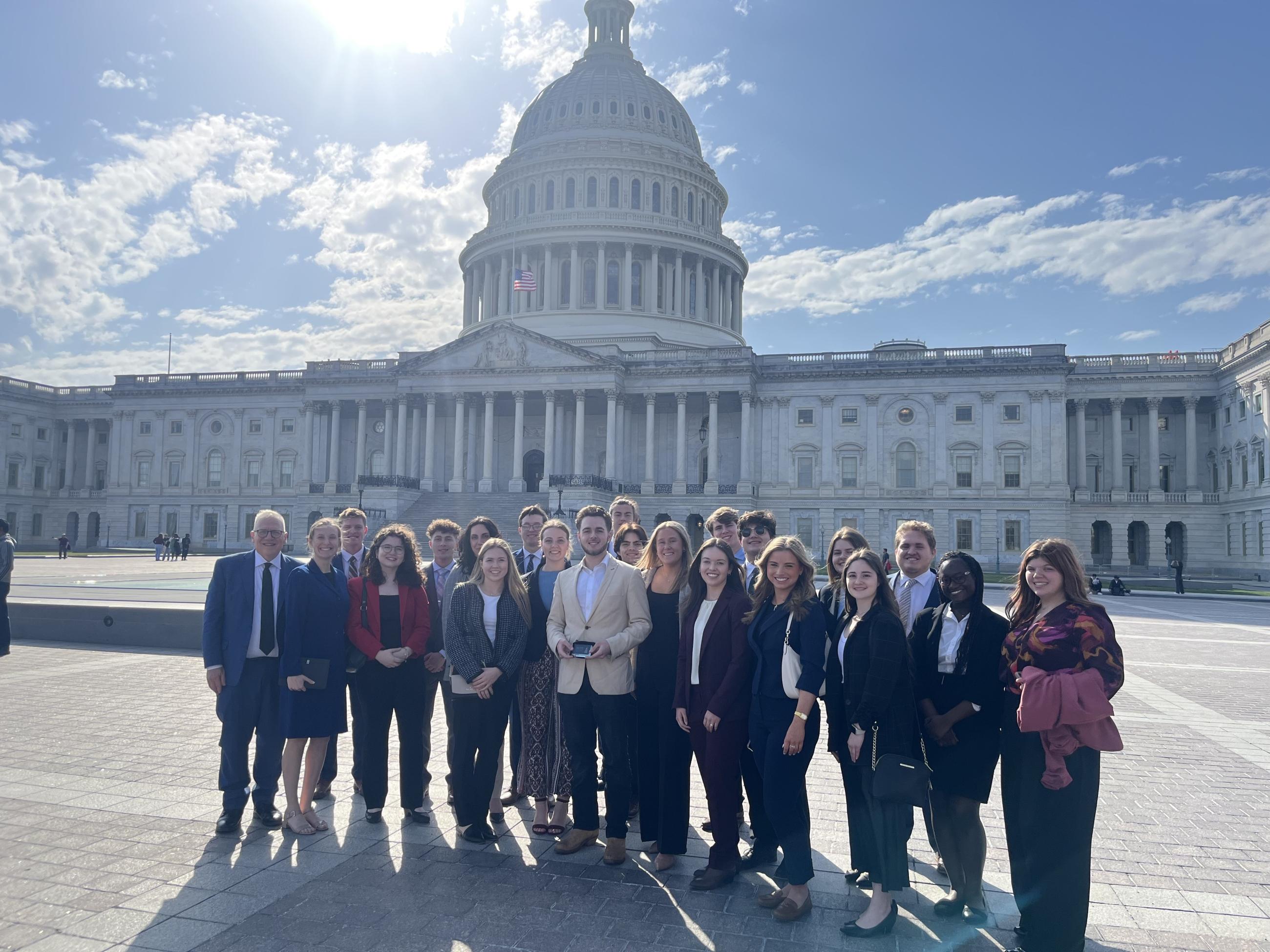 Stover Scholars pose outside of the Capitol with Stover Scholar alumnus Luke Diel