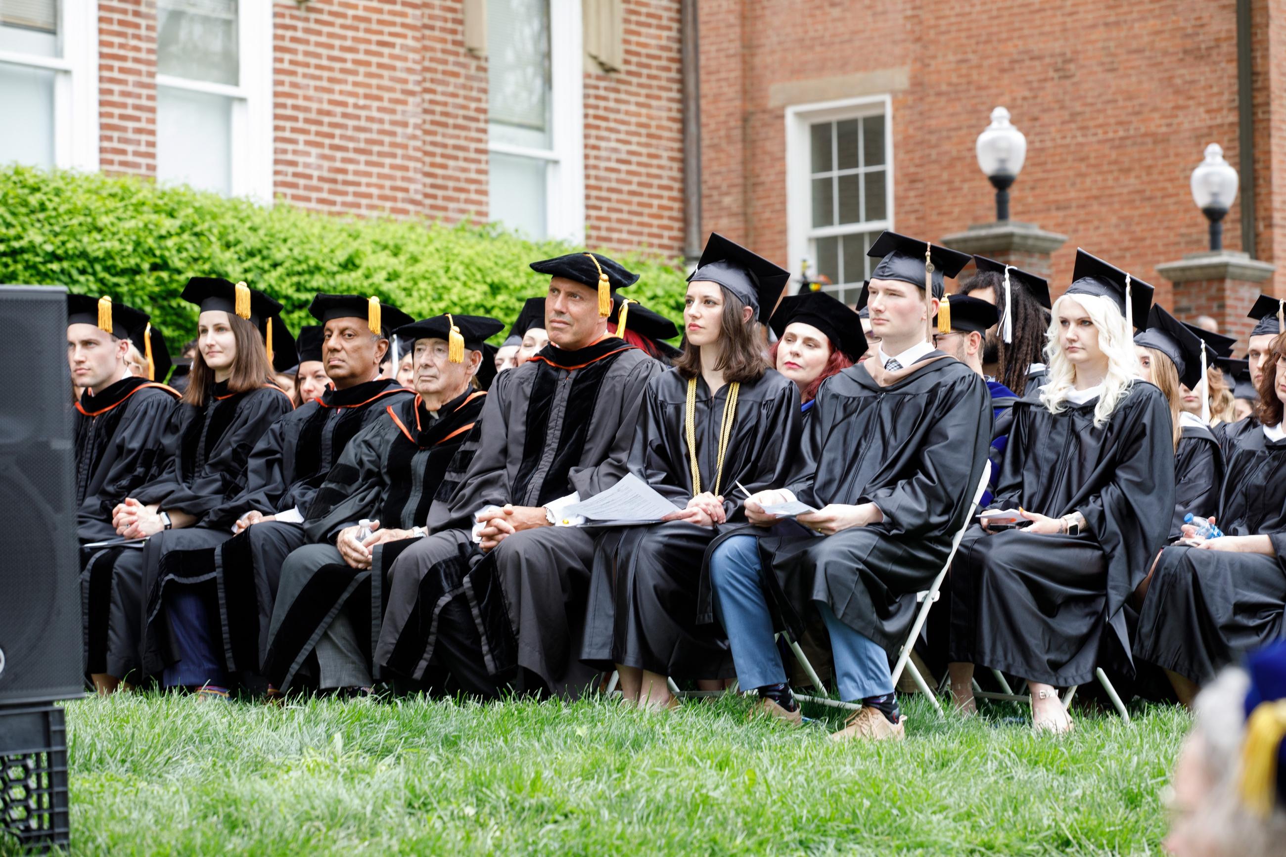 graduates sitting at commencement