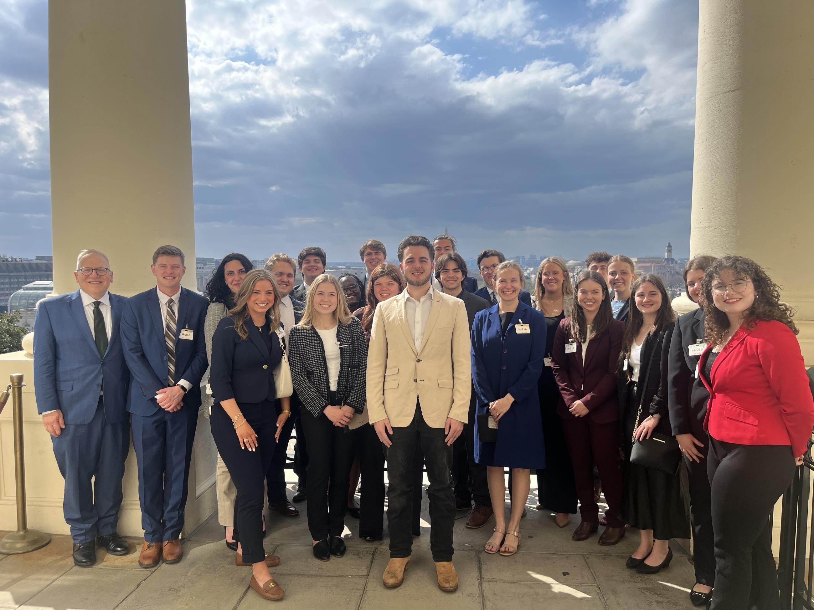 Stover Scholars pose on Speaker's Balcony with Stover alumnus Luke Diel