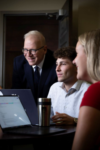 Dr. Stratton and Stover Scholars talk around a table