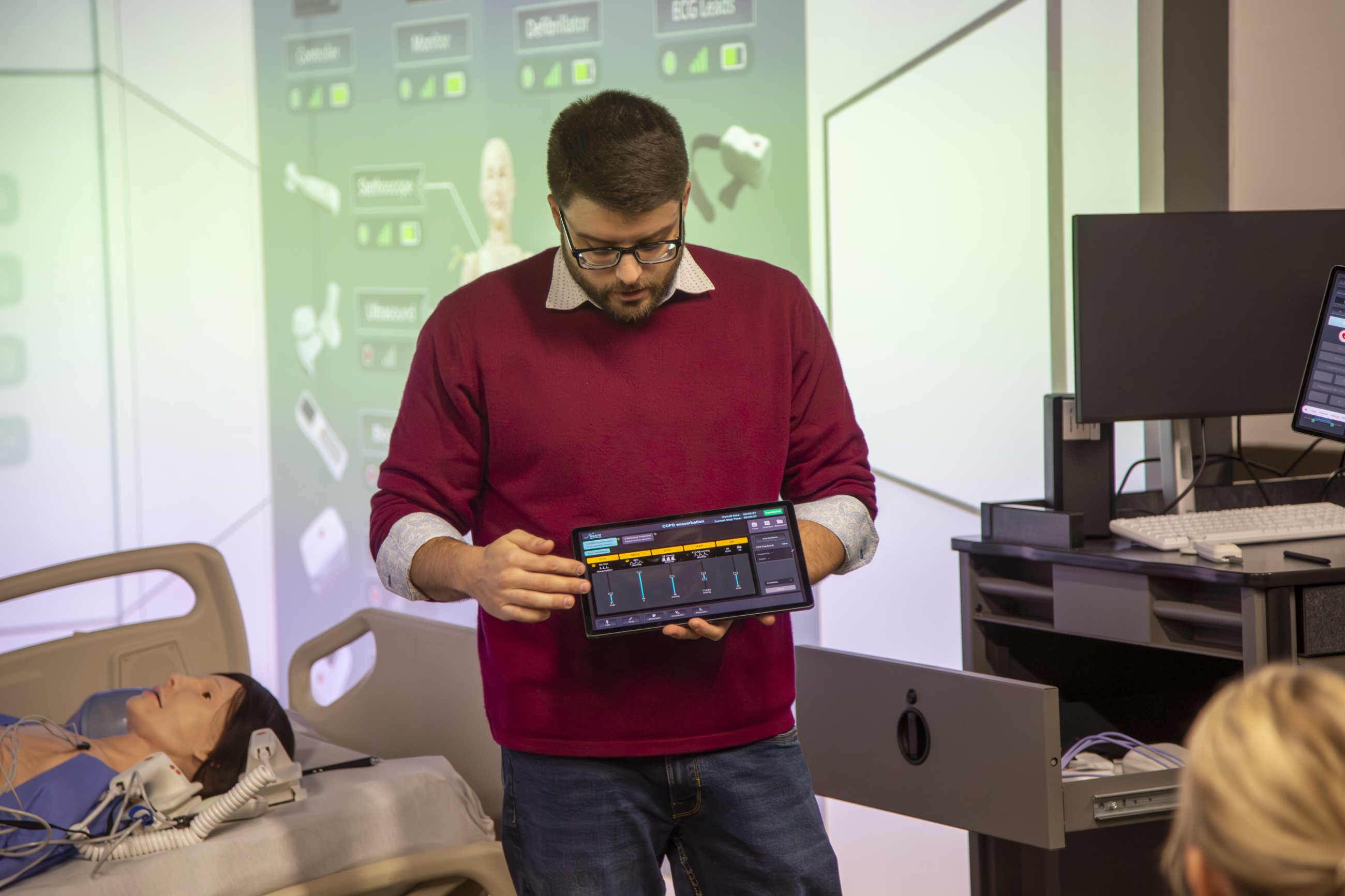 Man operating controllers for Nursing Immersion Room.