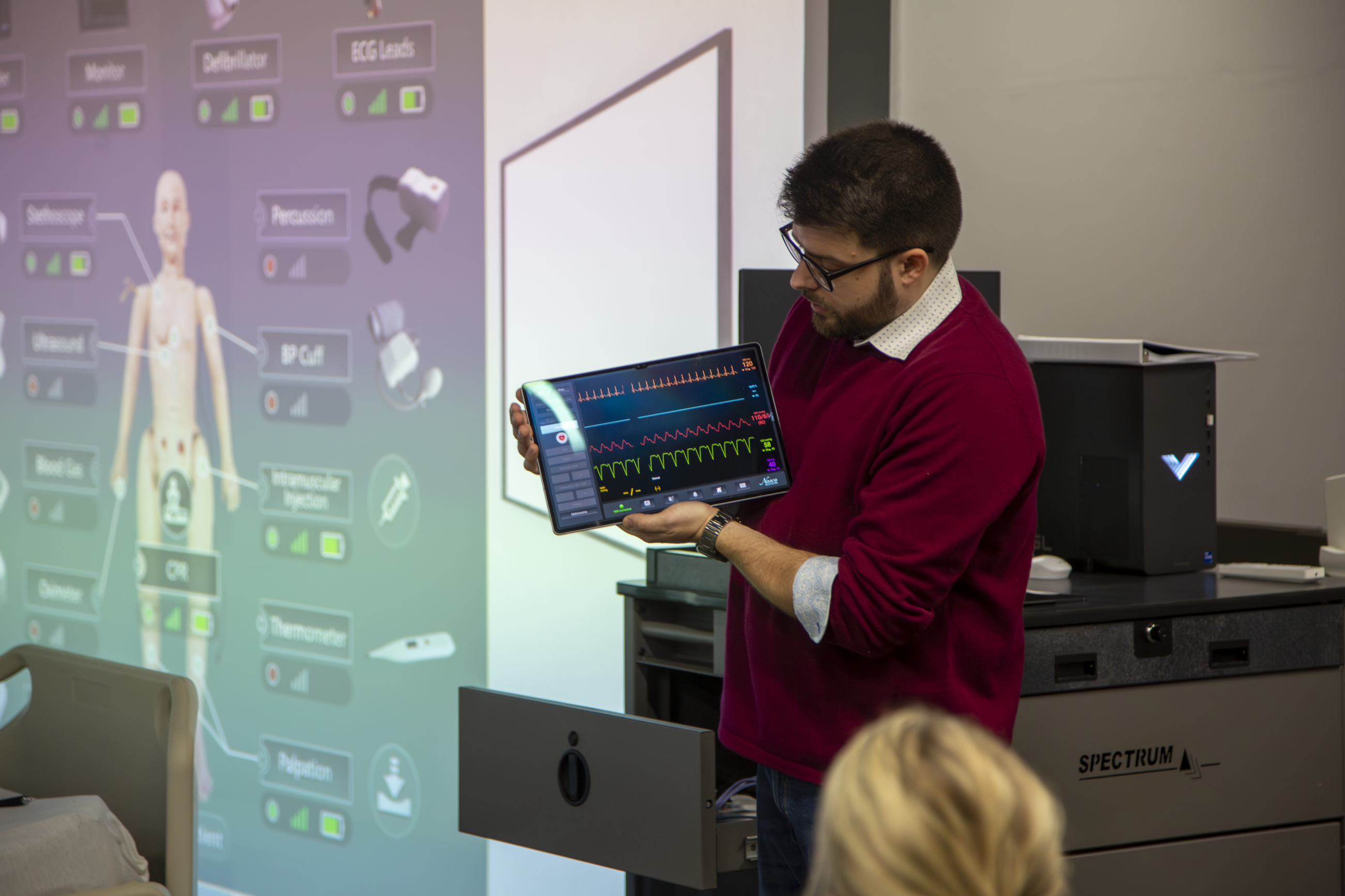 Man operating controllers for Nursing Immersion Room.