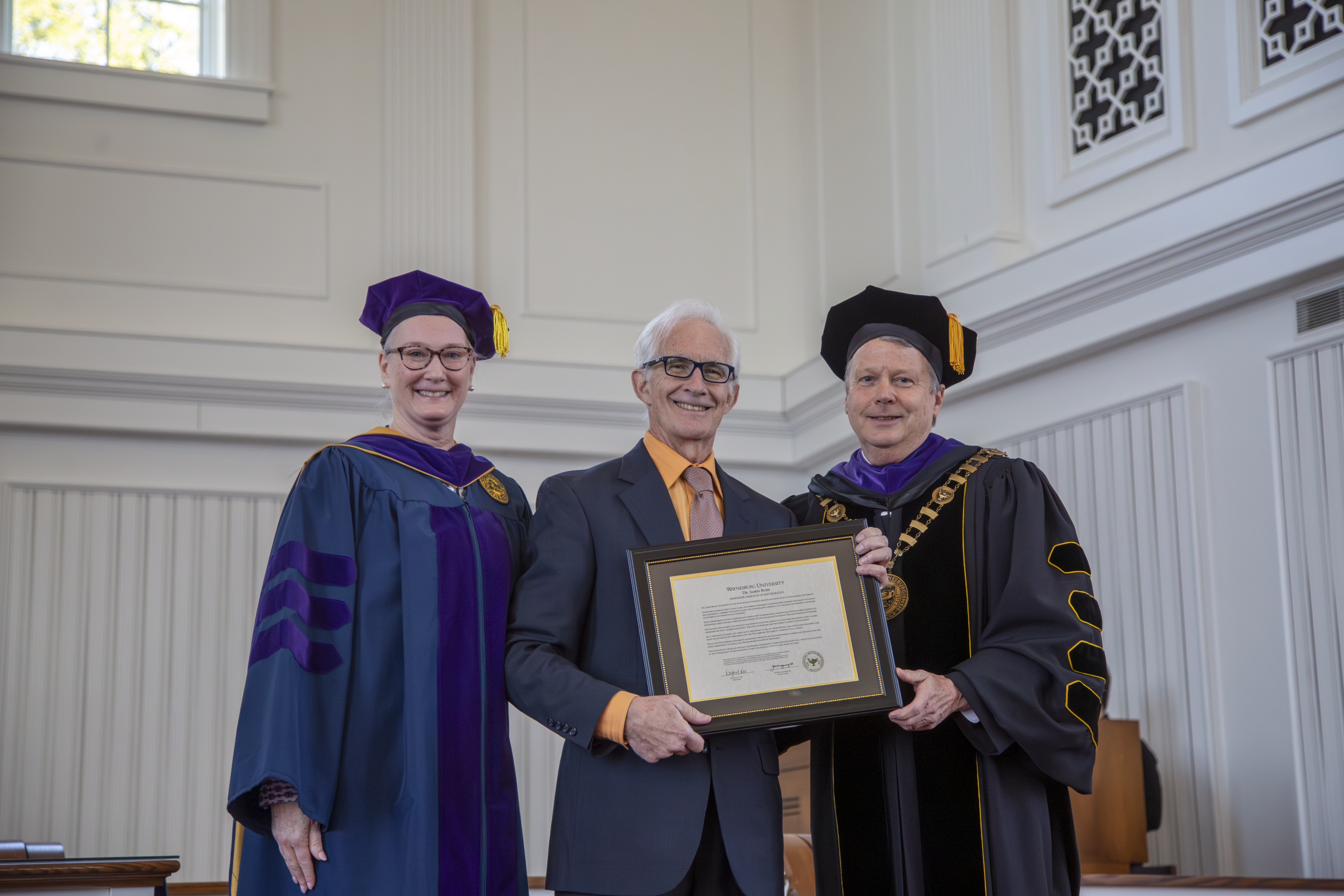 Dr. James Bush (center) accepting his professor emeritus award from Provost Walls and President Lee
