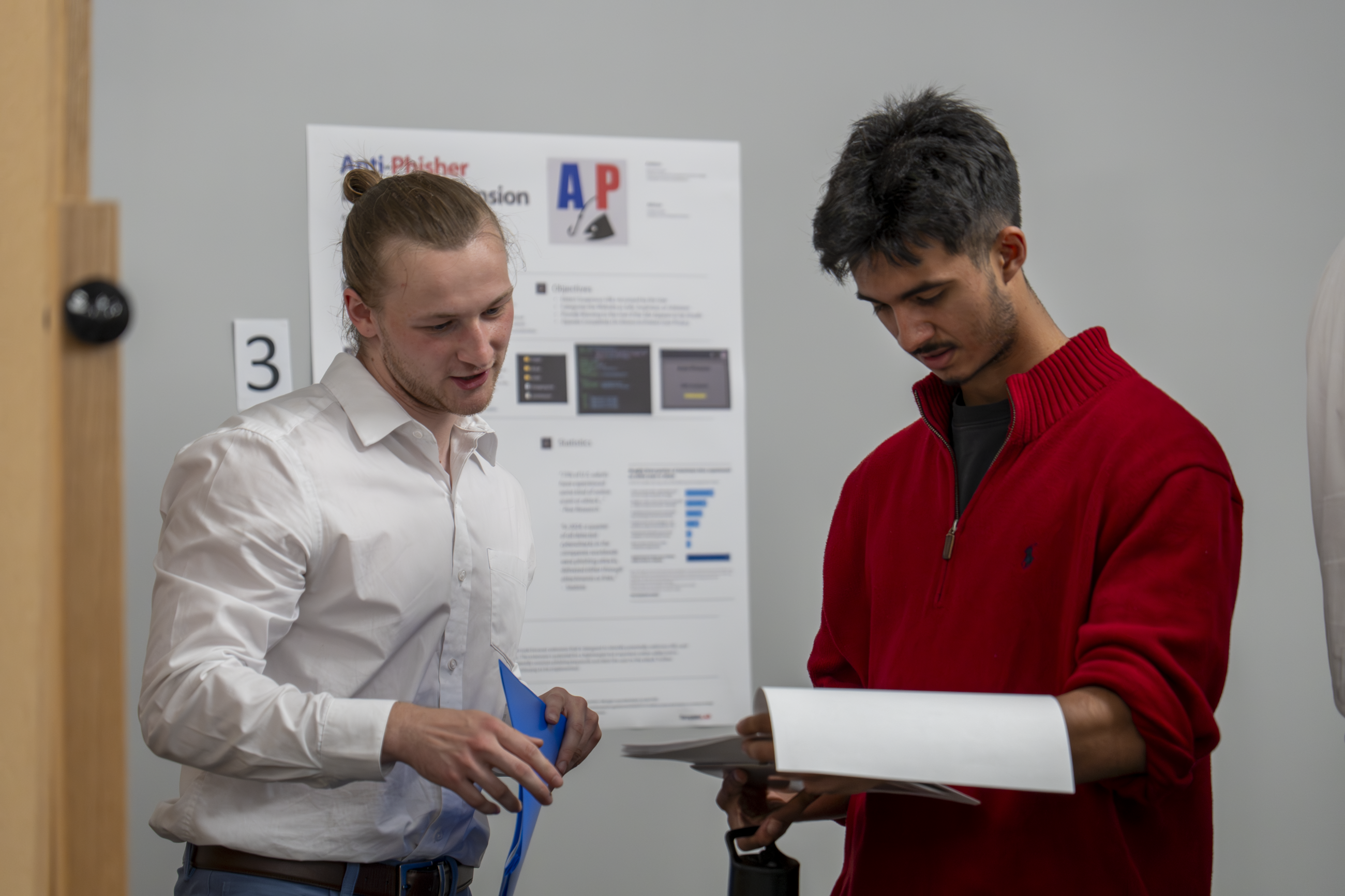 Fellow students discussing and reviewing each others' research