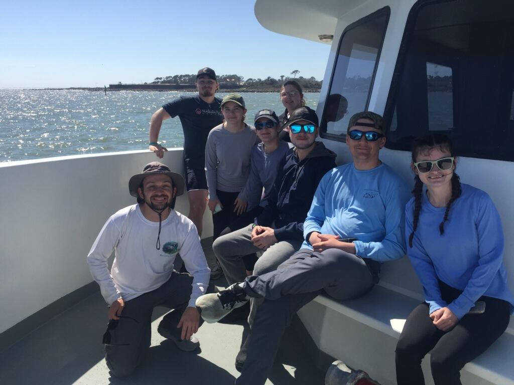 Dr. Hayes (far left) and biology students on a boat in Dauphin Island, Alabama