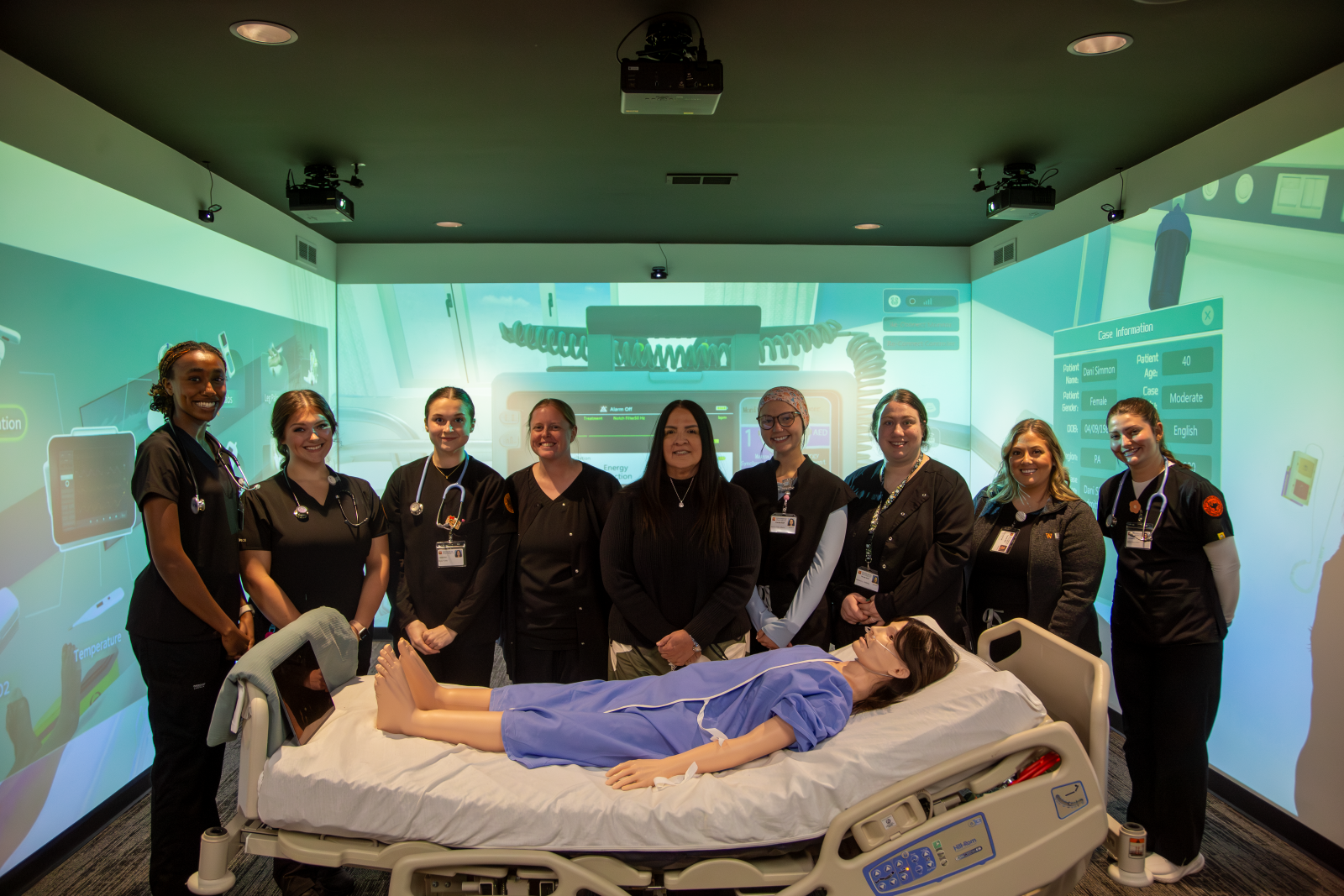 Waynesburg University nursing students and instructors pose in the new Nursing Immersion Room.