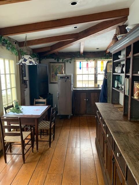 A table and counter with cabinets above it. 