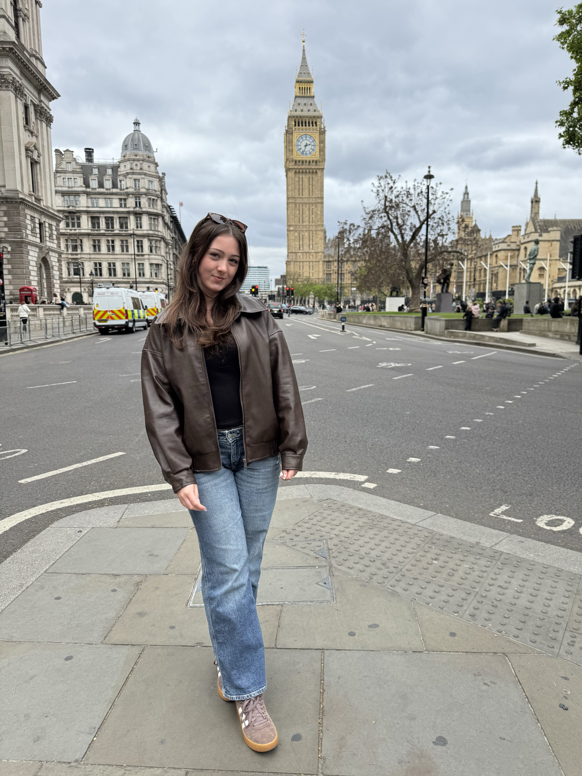 A female college student stands in front of the famous clocktower, Big Ben, in London, England 