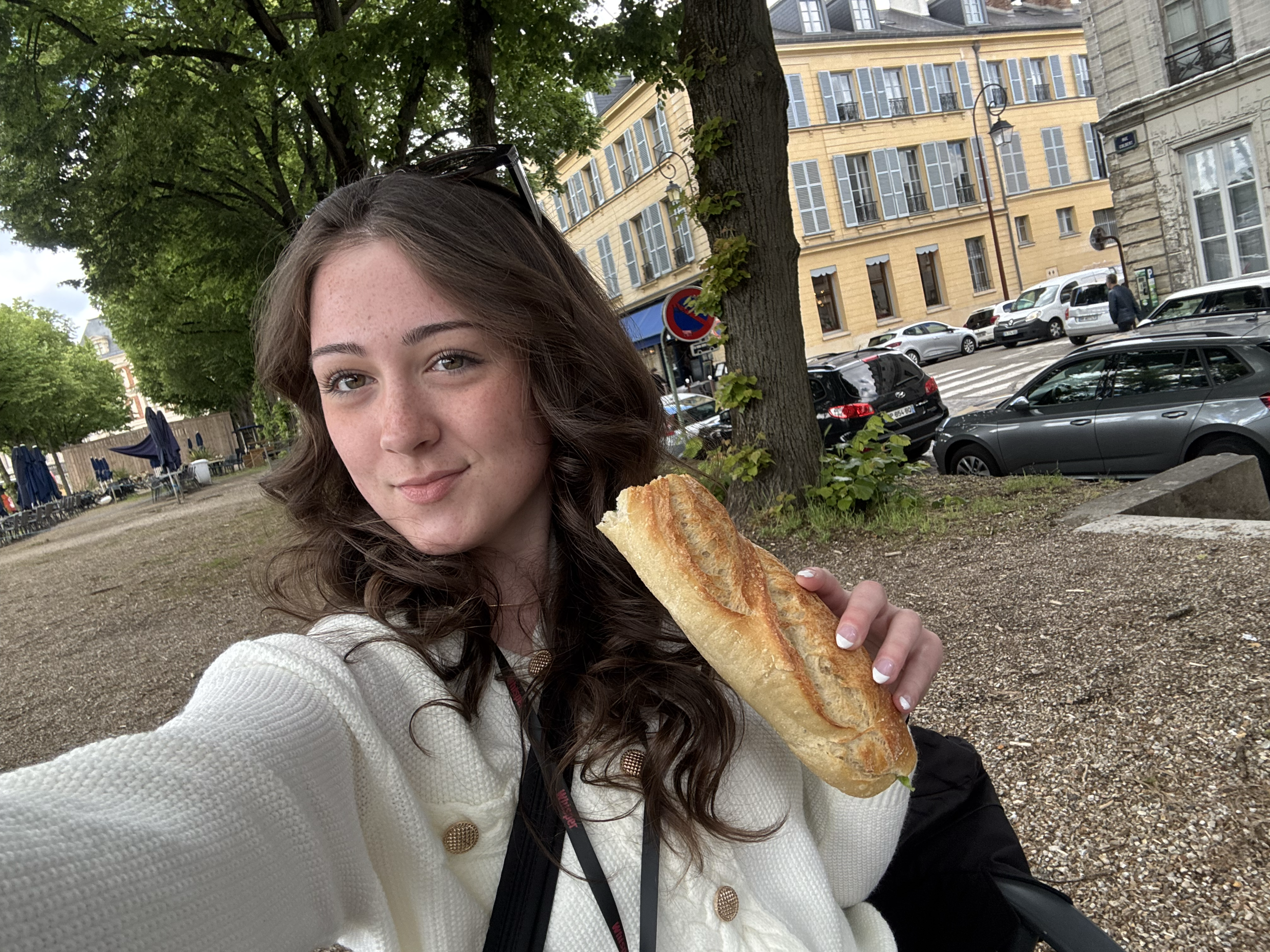 Meredith poses for a selfie with a baguette