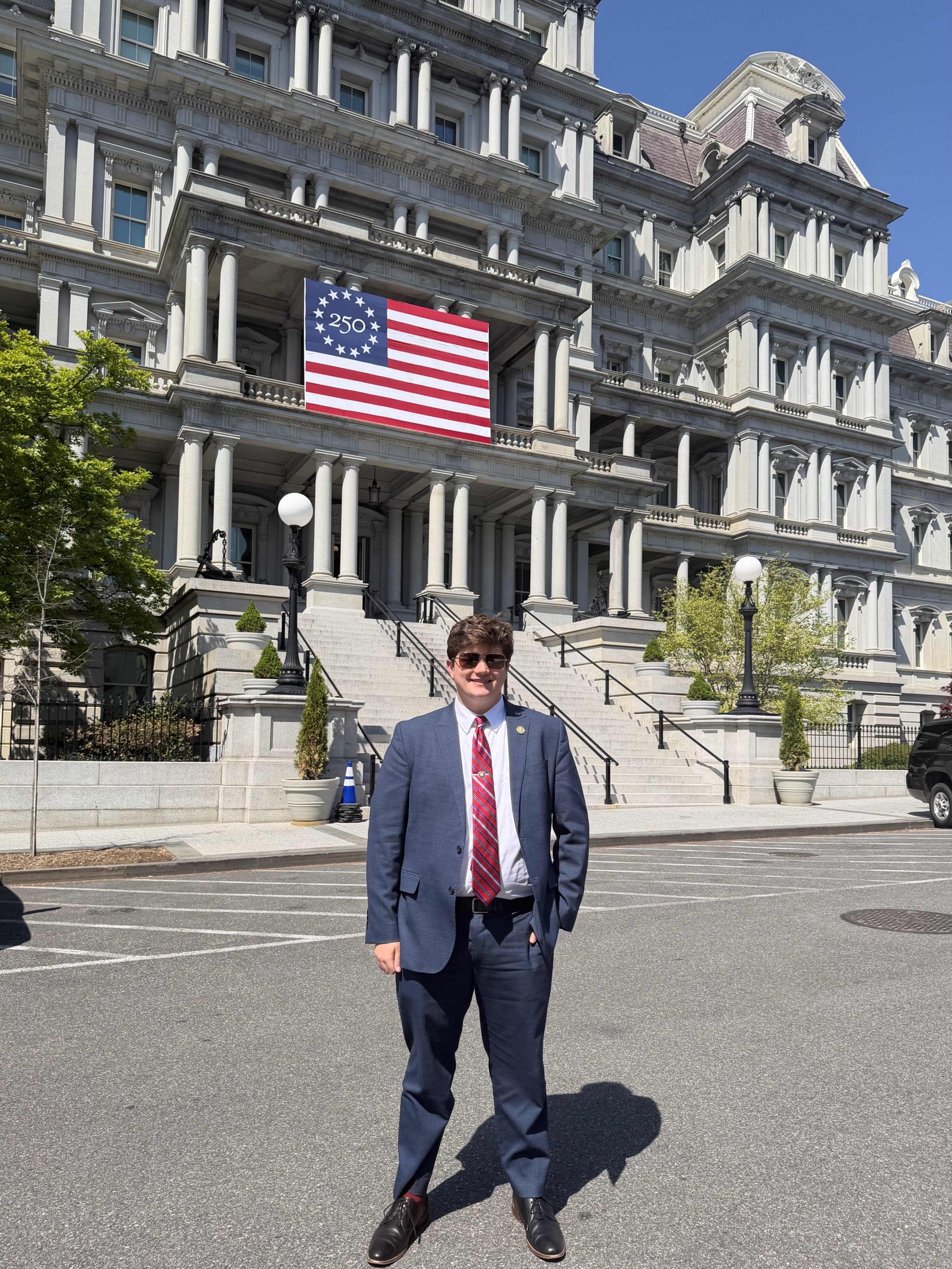 Solomon pictured in front of the Eisenhower Executive Office Building on the last day of his internship
