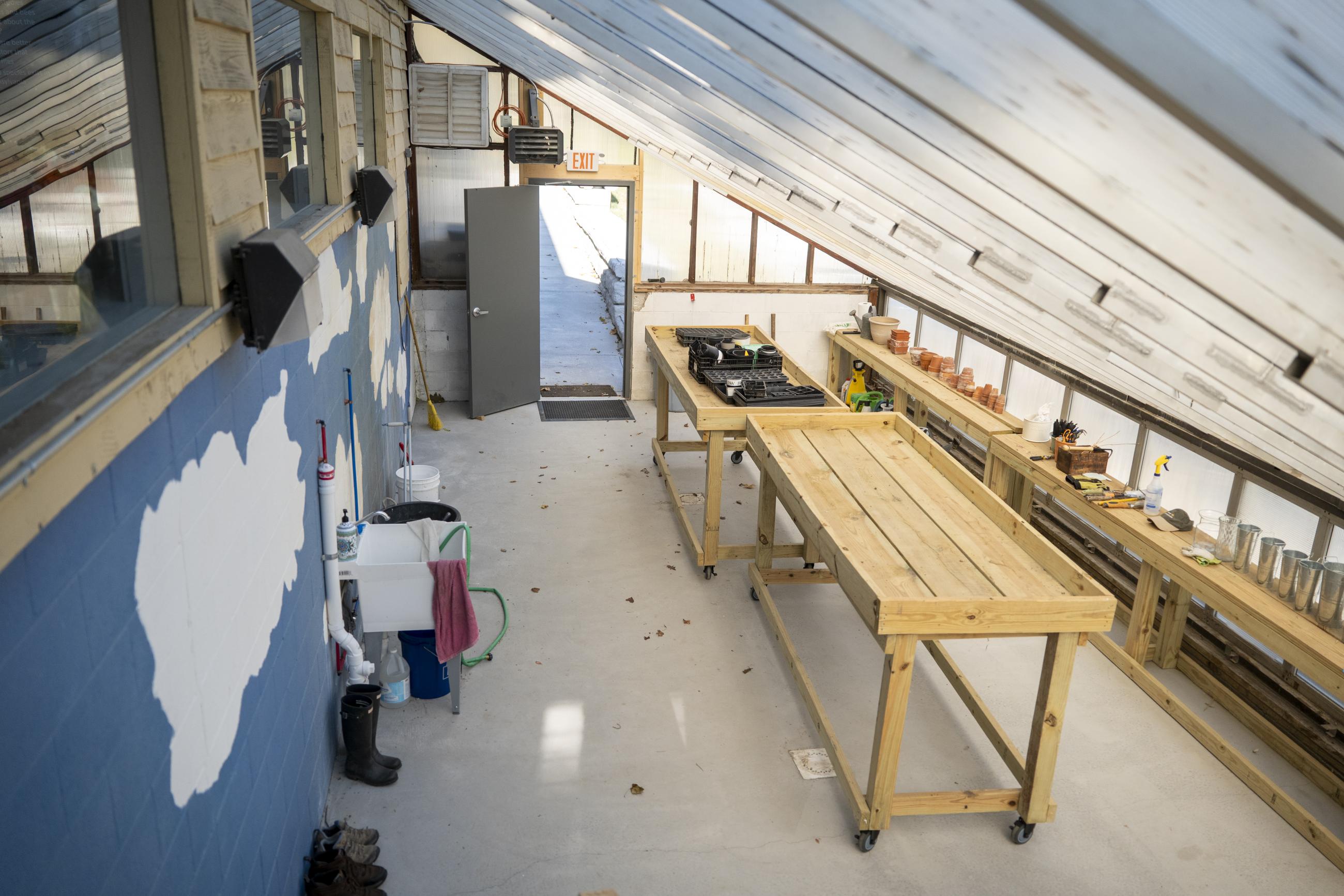 Interior of greenhouse with table and skylights. 