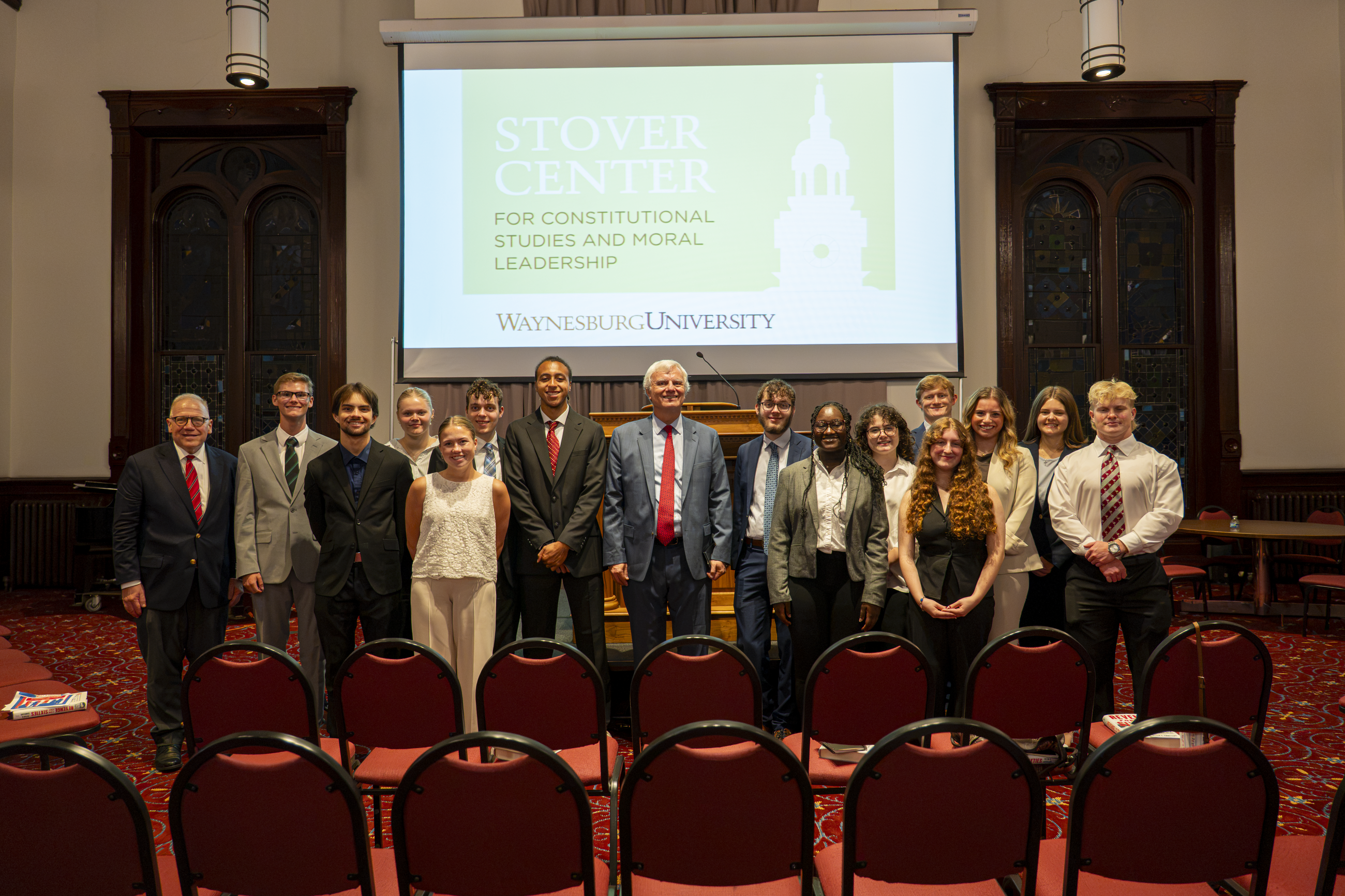 Peter Canellos pictured in Alumni Hall on Waynesburg University's campus, posing with Dr. Lawrence Stratton and members of the Stover Center for Constitutional Leadership program