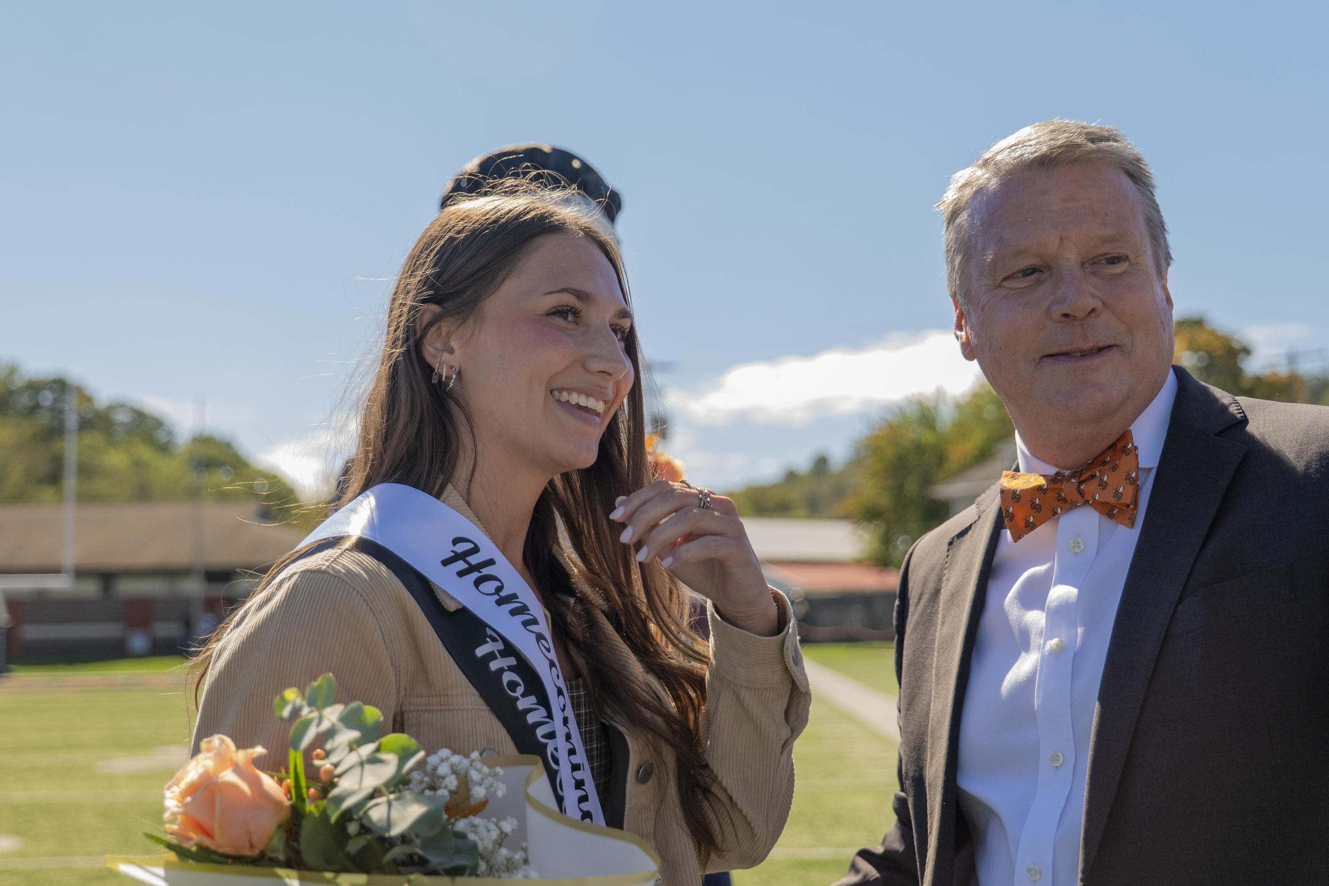 President Doug Lee bestowing the white sash upon Homecoming Queen Mia Henkins
