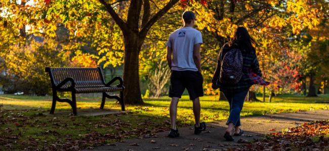 Students walking on campus during the fall