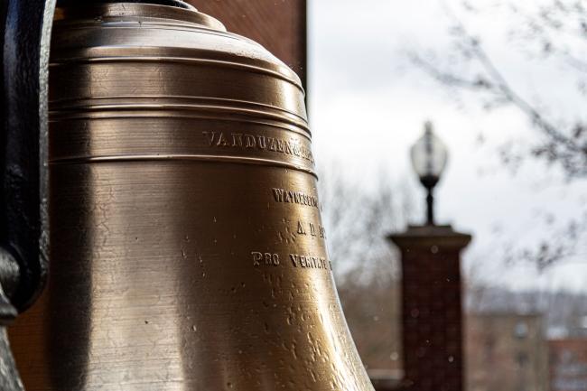 The bell in Cusick Court next to Hanna Hall