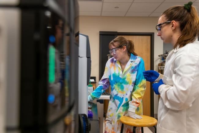 Waynesburg students working in the chemistry lab with NMR equipment