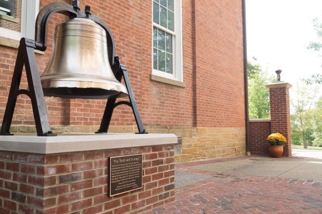 The restored bell from Hanna Hall sitting outside the building in Cusick Court