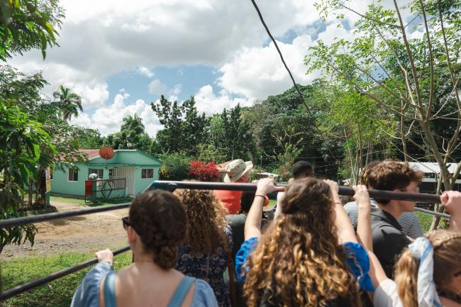 Waynesburg students look out at the greenery as they ride on the back of a blue cattle truck.