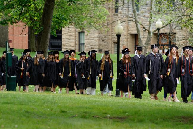 graduates process through the park 