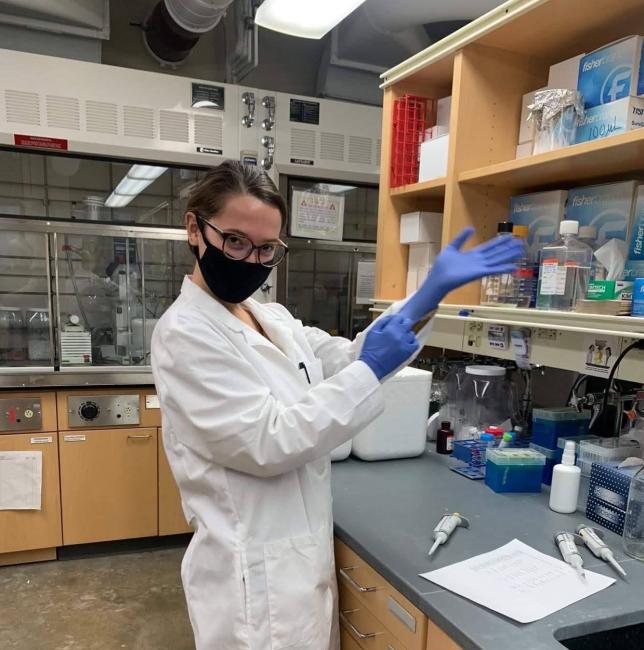 Heather Allaman in a lab with gloves and a face mask