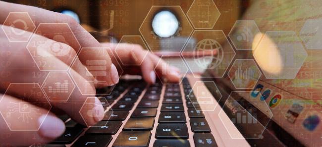 Student typing on a keyboard with data analytics graphics overlaid on the image