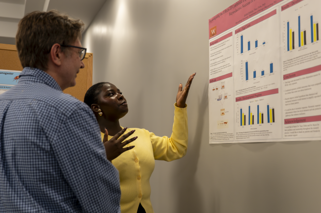 Student presenting research poster to Dr. Chris Cink