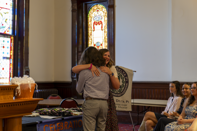 Kelsey Sprowls hugging an Education student